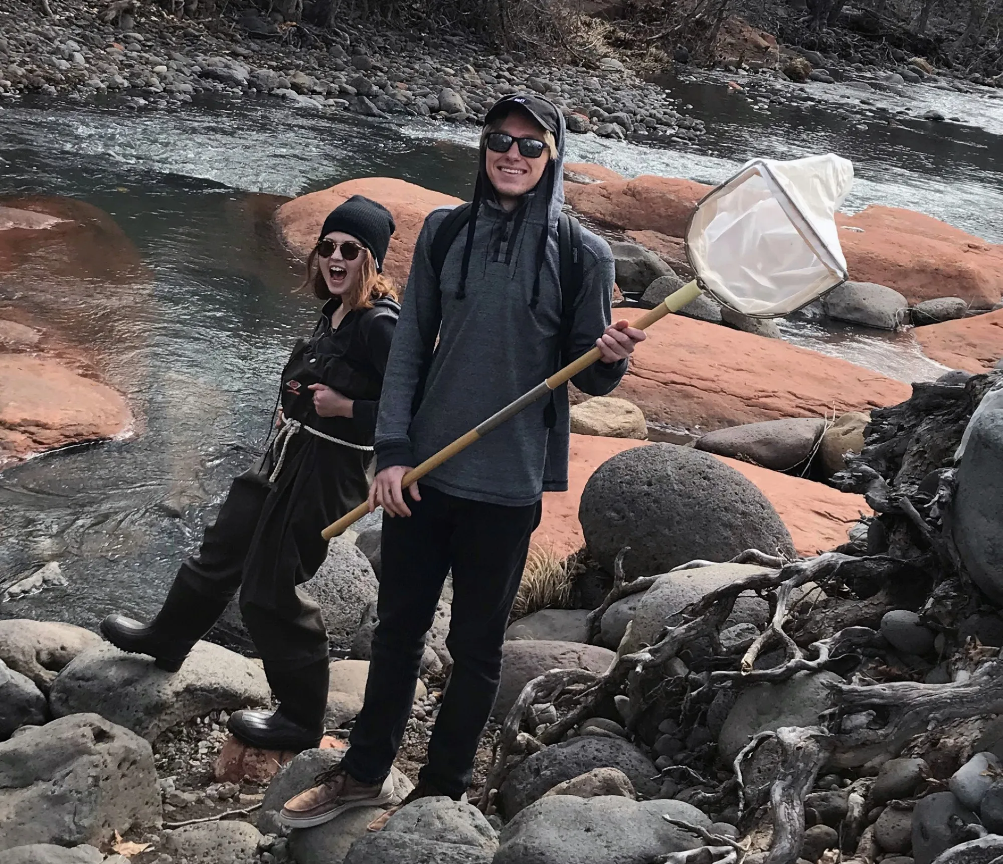 Stream ecology students sampling in waders